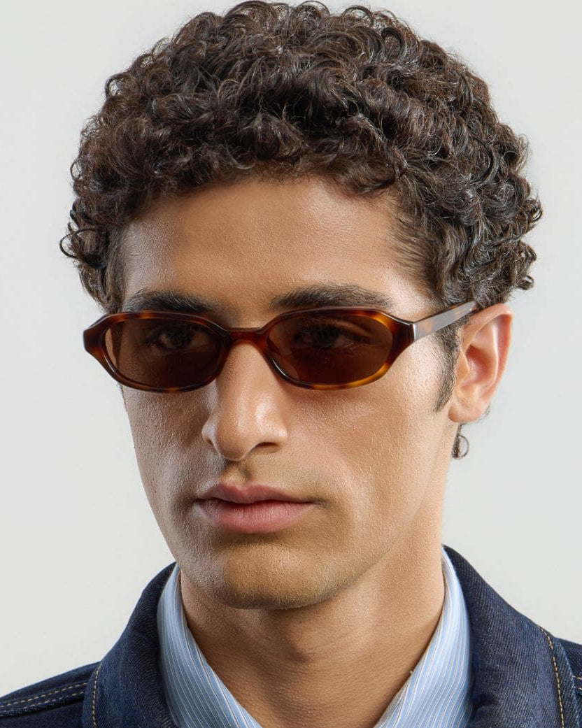 Male model wearing Corlin Eyewear Aidan Tortoise Brown sunglasses — side profile, modern Scandinavian eyewear