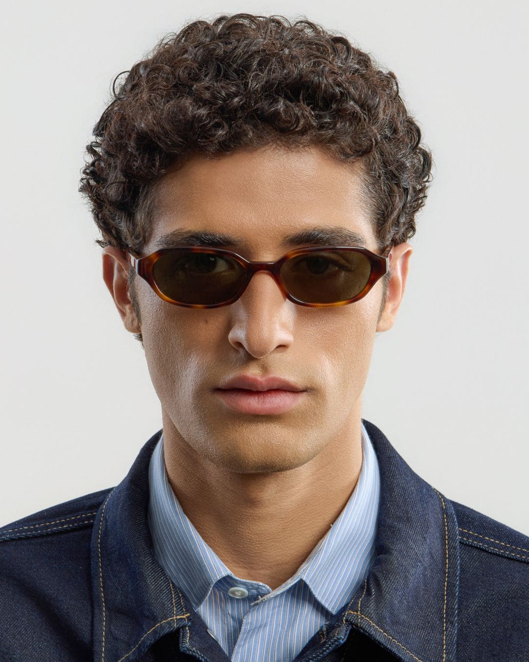 Man wearing Aidan Tortoise Green sunglasses by Corlin from front.