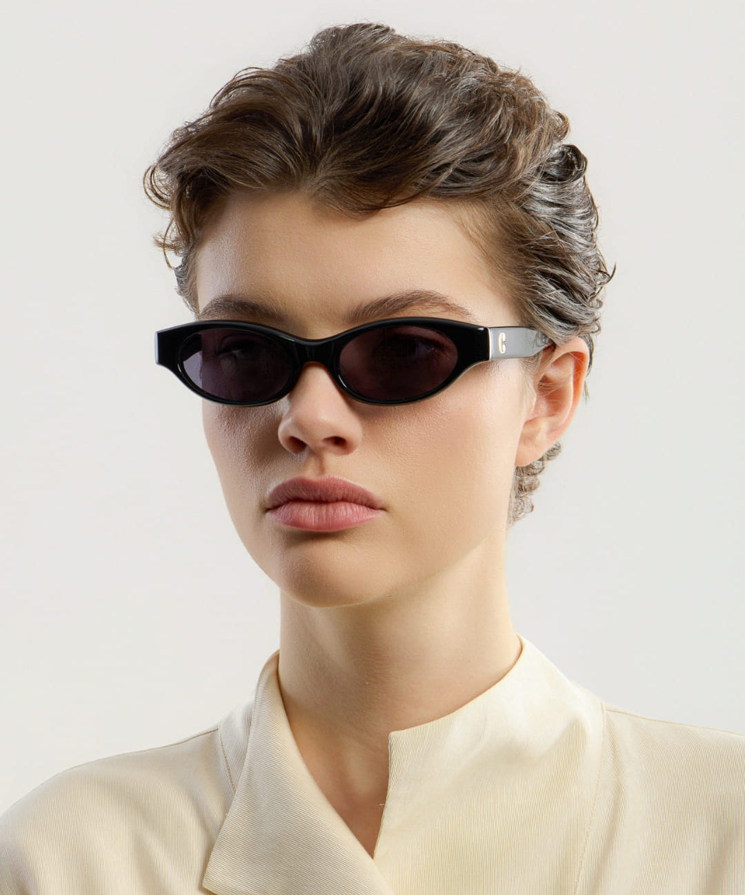 Female model wearing Corlin Eyewear Alba Black Black sunglasses — side profile, Swedish minimalist design