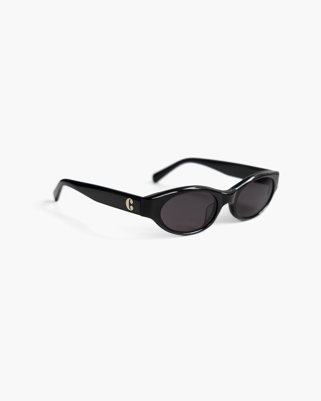 Black sunglasses on a white background slightly from the side