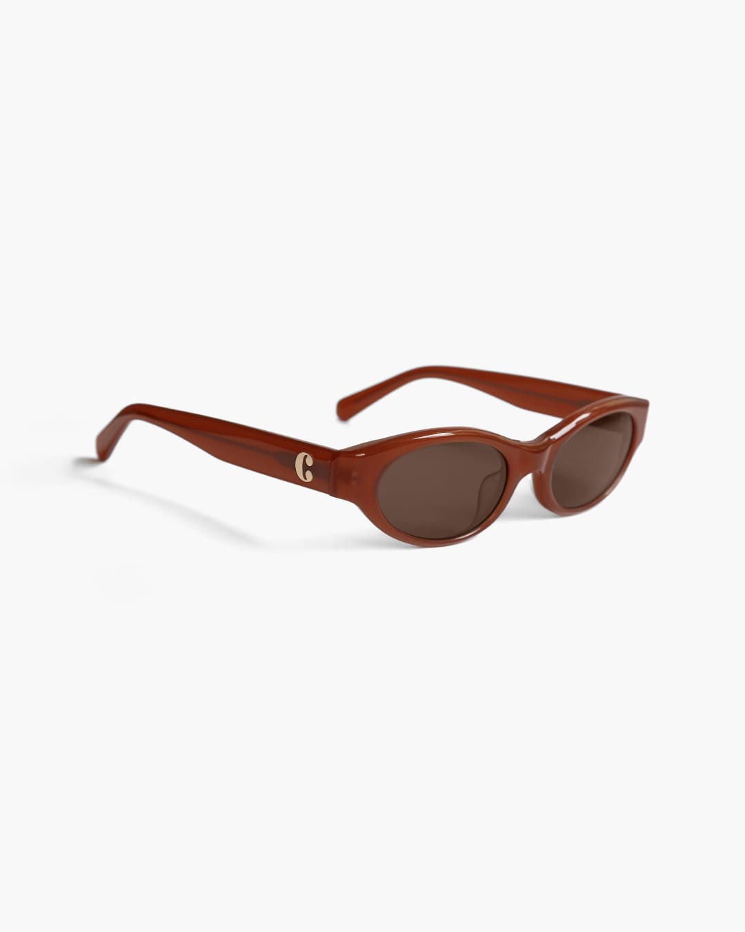 Red brown sunglasses with a gold logo on a white background