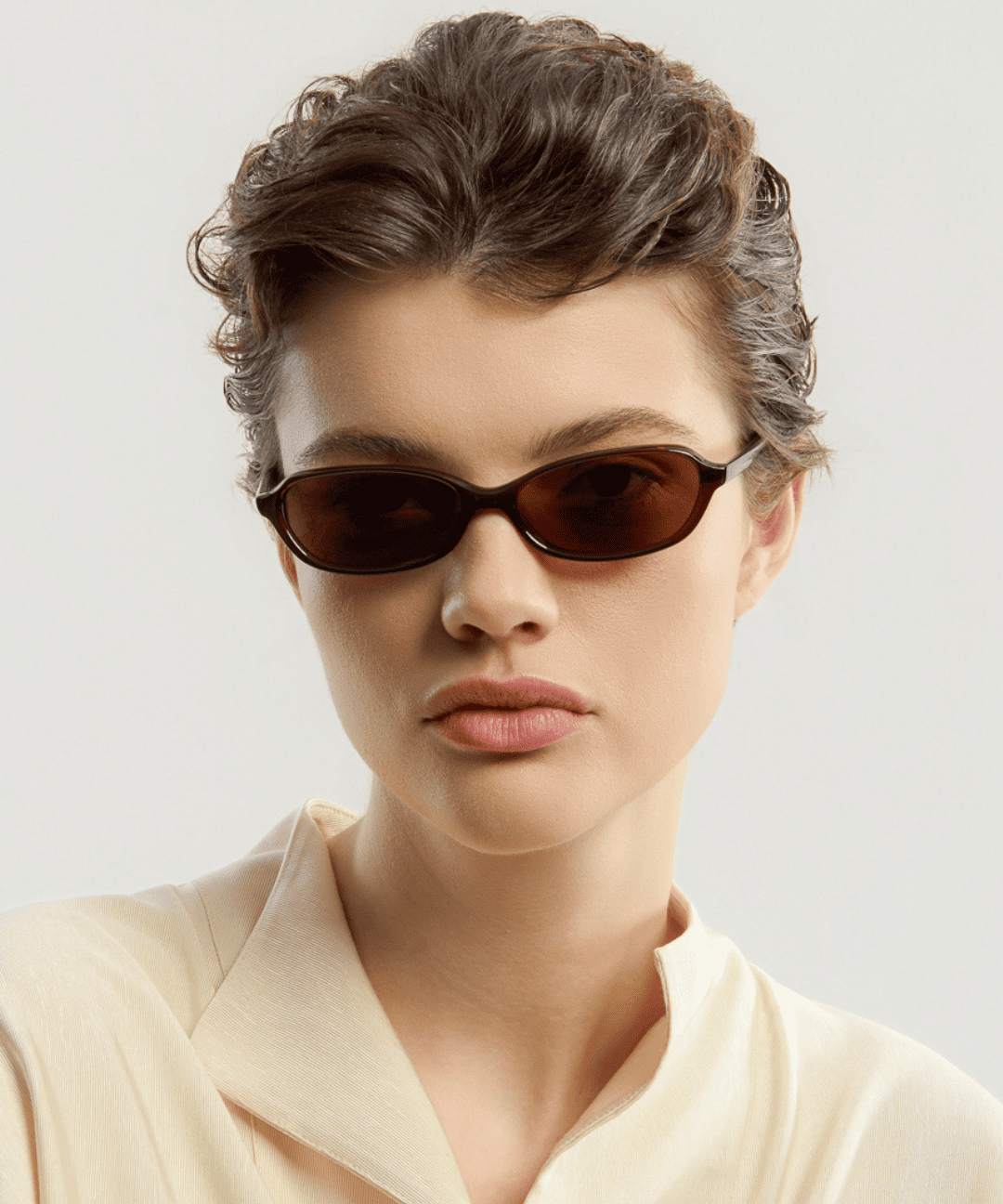 Female model wearing Corlin Eyewear Ana Brown Brown sunglasses — timeless cat-eye eyewear, Scandinavian design