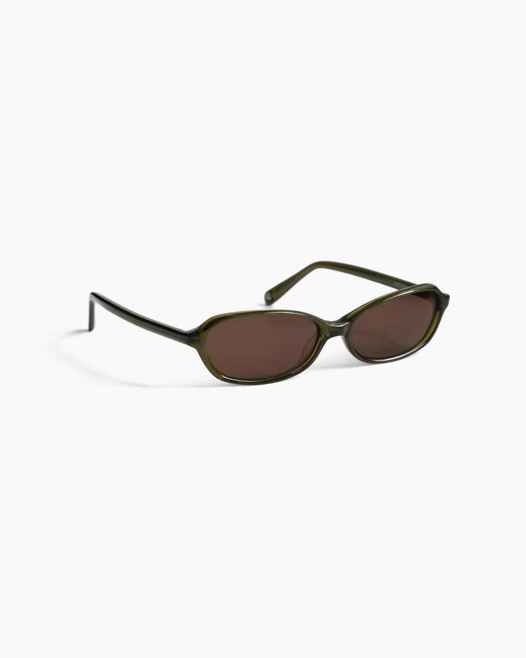Sunglasses with green frame and brown lenses on a white background slightly from the side