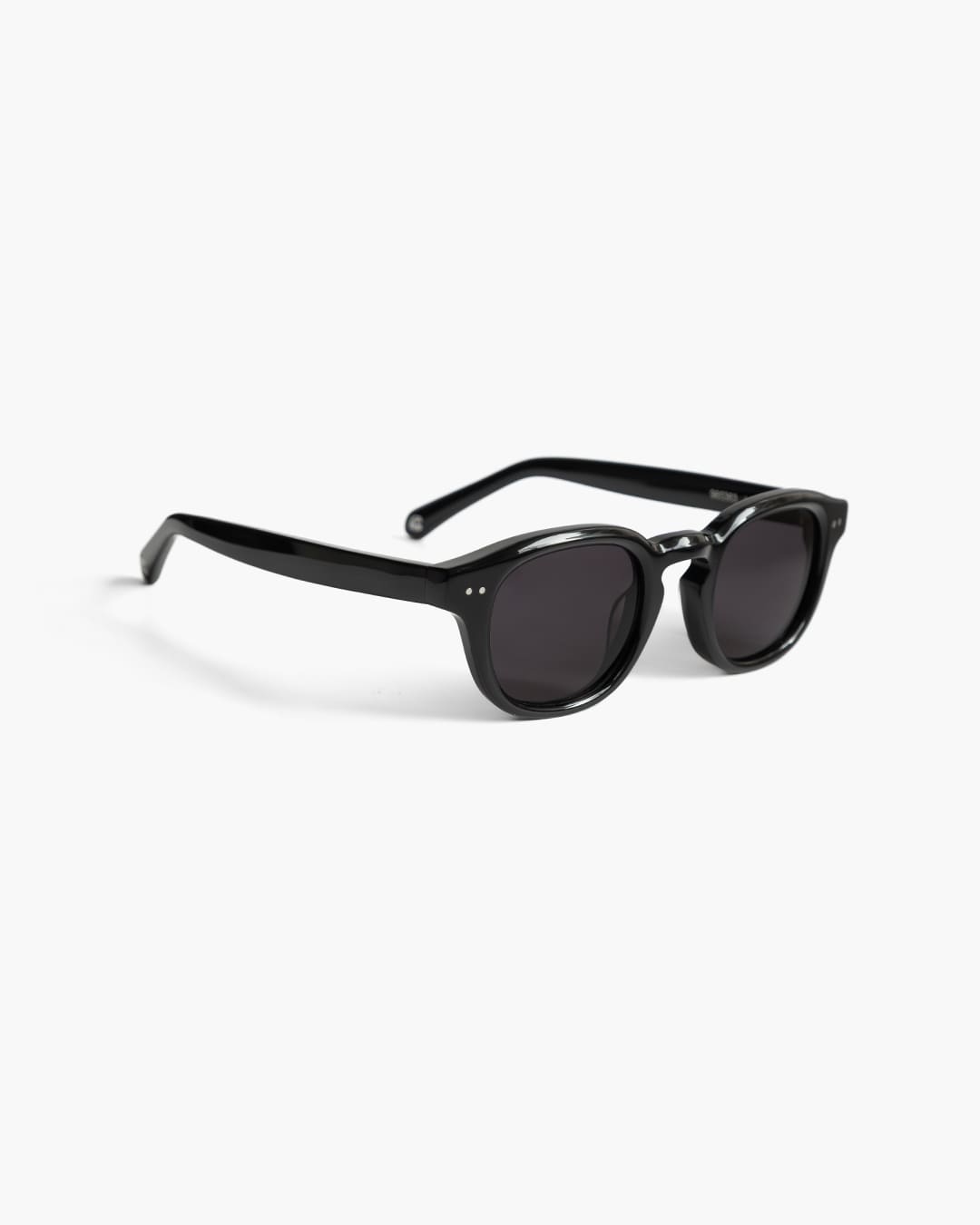 Black sunglasses on a white background slightly from the side