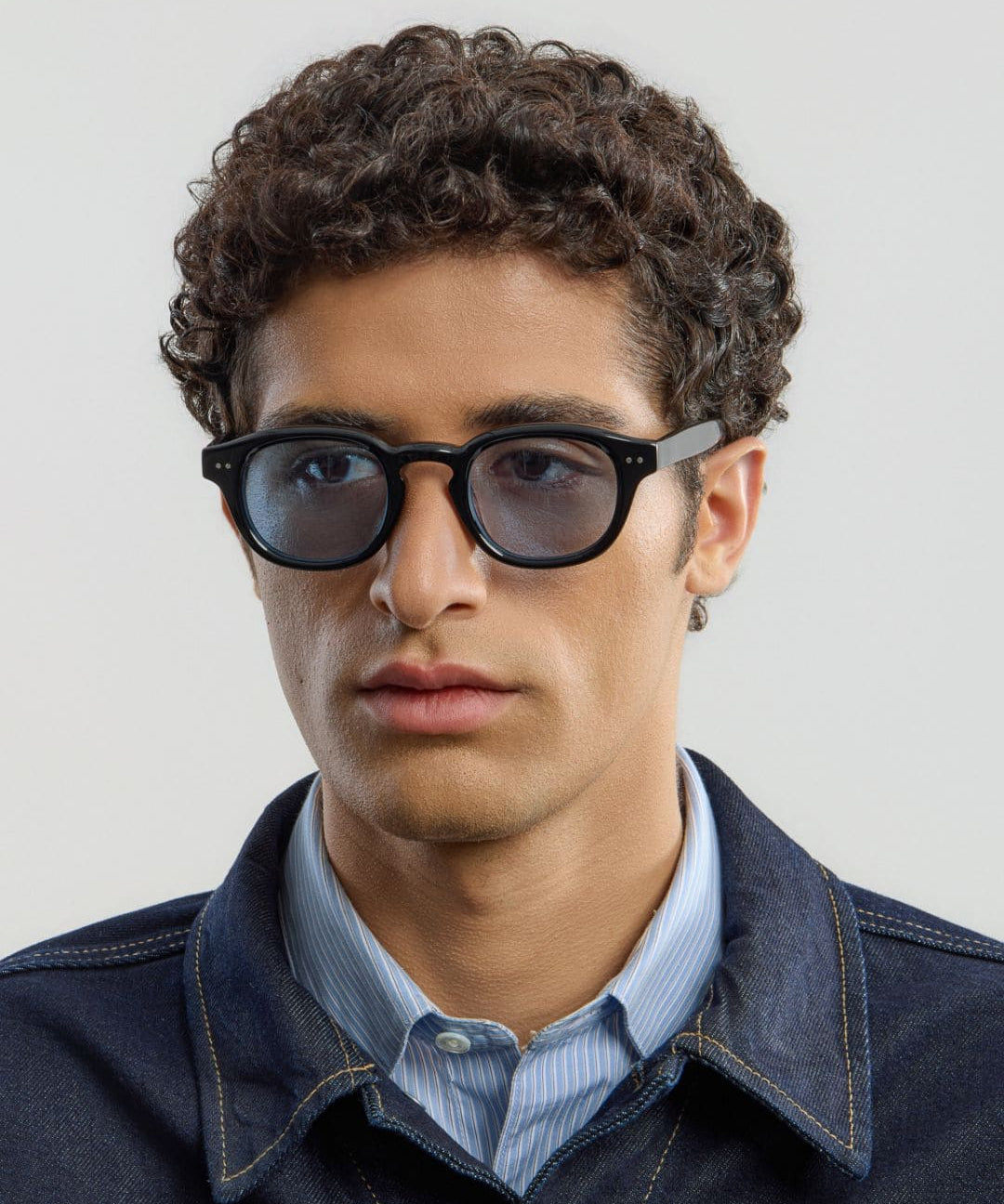 Male model wearing Corlin Eyewear Idris Black Blue sunglasses — side profile, modern Scandinavian eyewear