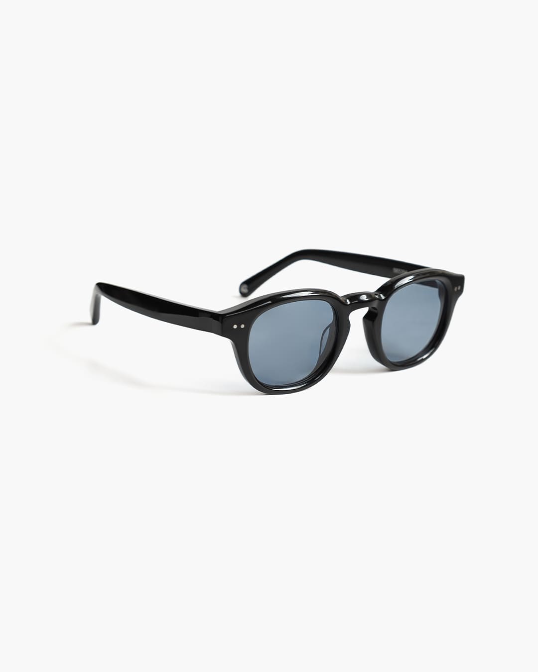 Black sunglasses with blue lenses on a white background slightly from the side