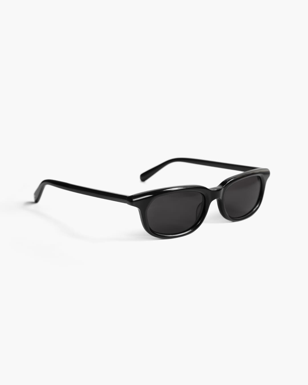 Black sunglasses on a white background slightly from the side