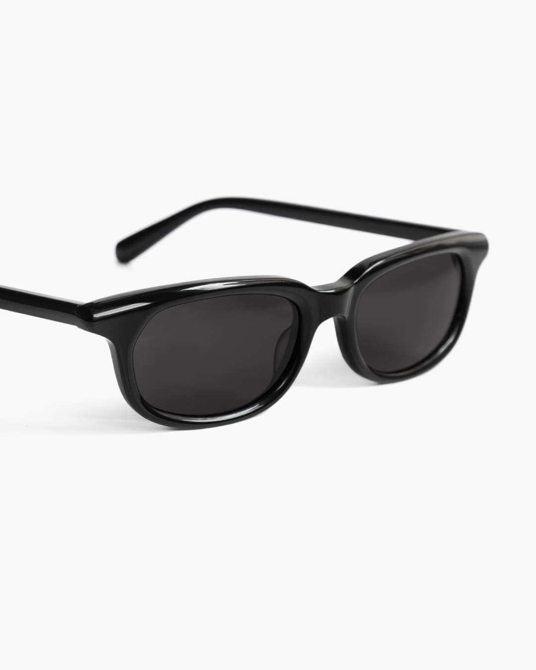 Closeup of black sunglasses on a white background
