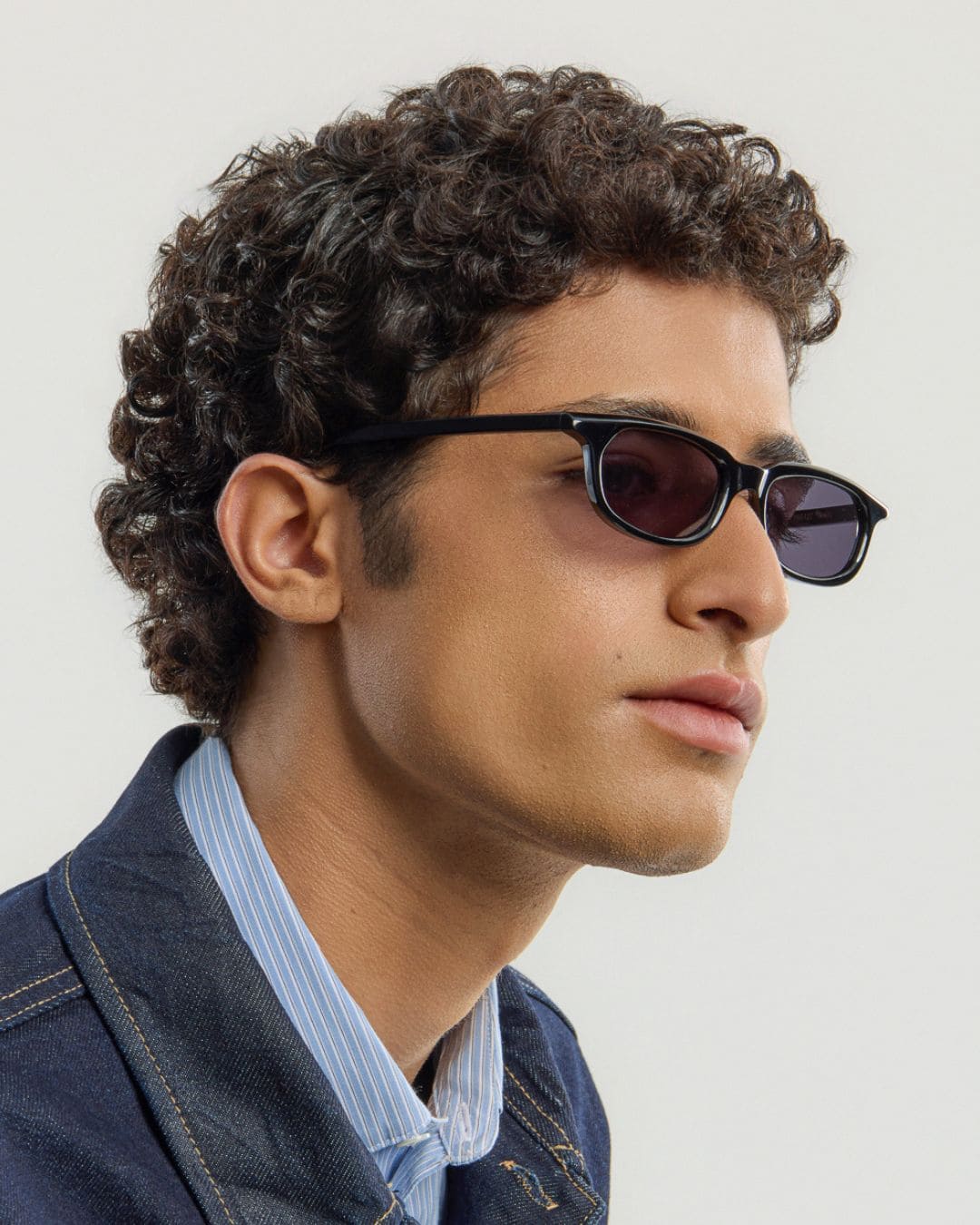 Male model wearing Corlin Eyewear Jean Black Black sunglasses — classic unisex eyewear, Scandinavian design