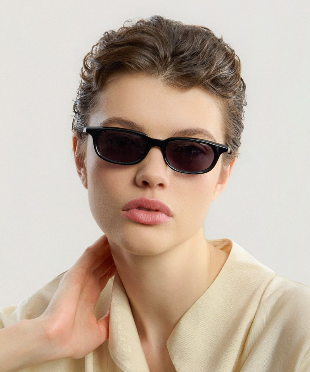 Female model wearing Corlin Eyewear Jean Black Black sunglasses — timeless unisex eyewear