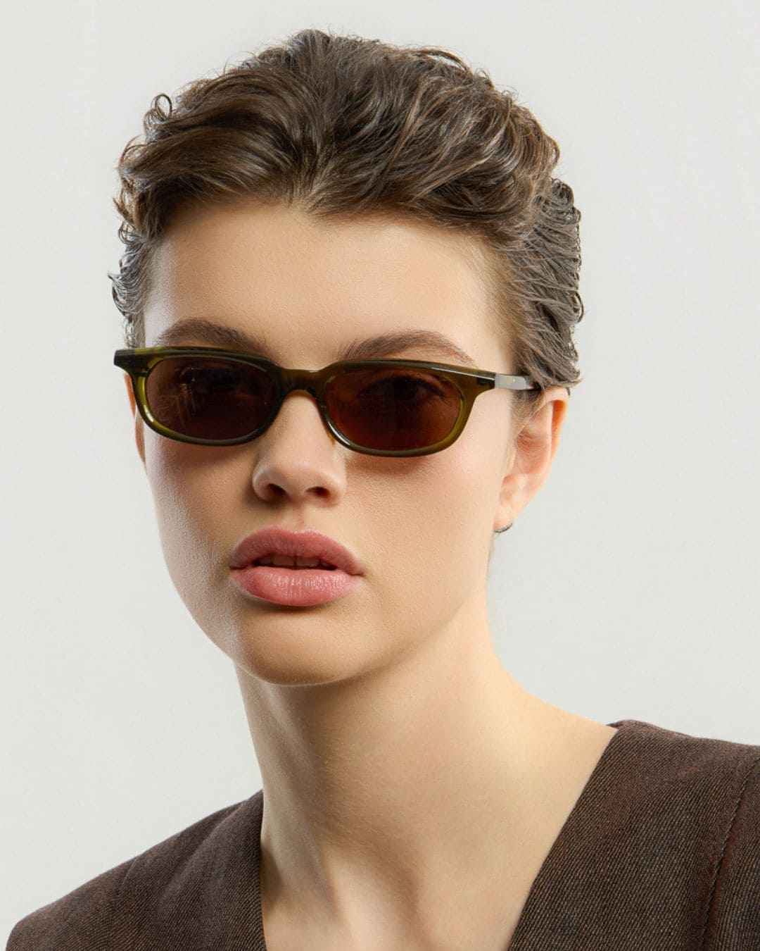 Female model wearing Corlin Eyewear Jean Olive Brown sunglasses — timeless unisex eyewear