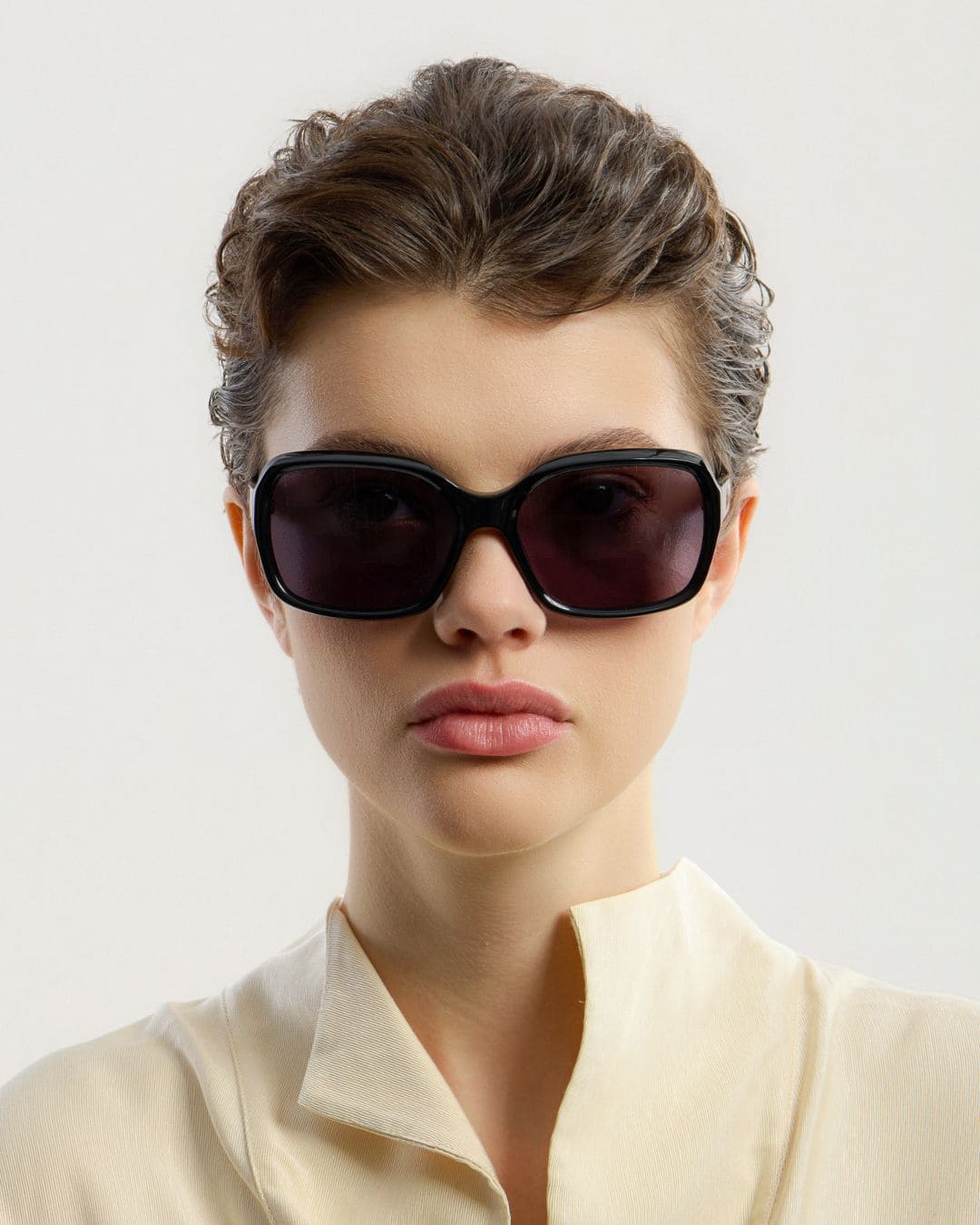 Female model wearing Corlin Eyewear Lana Black Black sunglasses — front view, bold squared Italian acetate frame