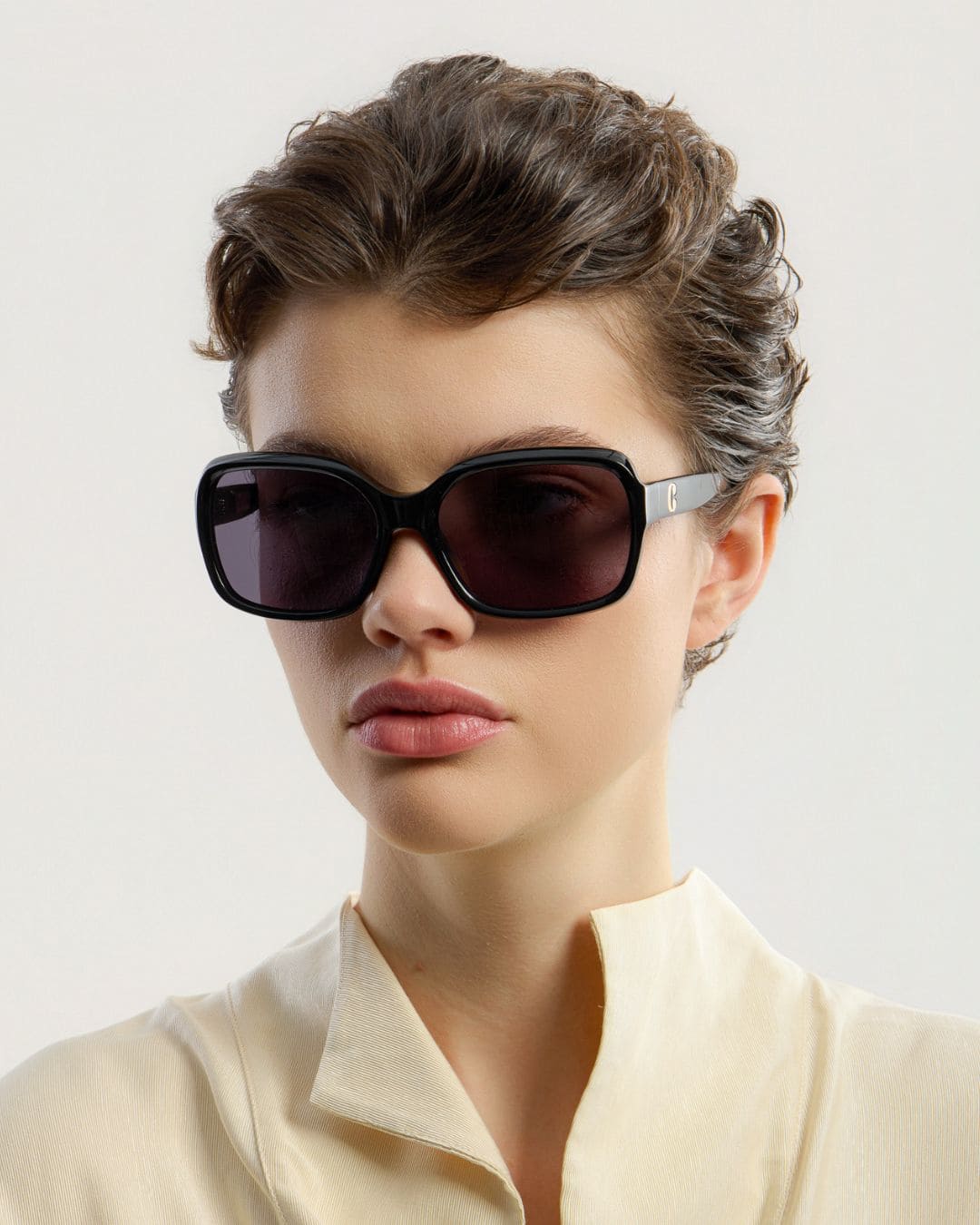 Female model wearing Corlin Eyewear Lana Black Black sunglasses — side profile, Swedish minimalist design