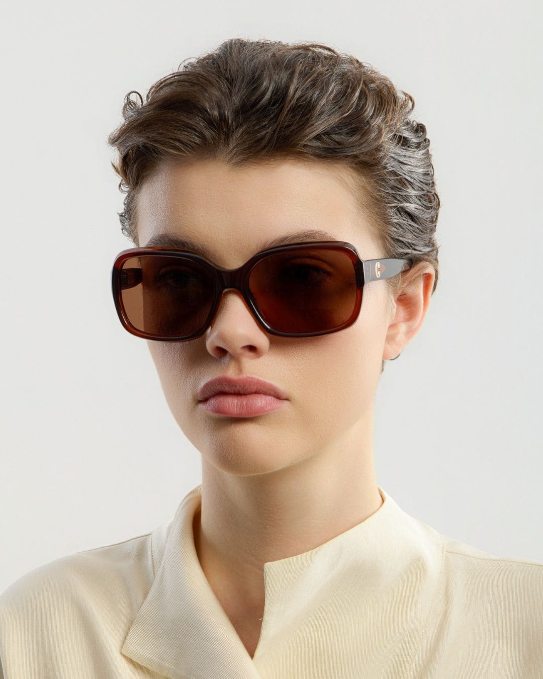 Female model wearing Corlin Eyewear Lana Brown Brown sunglasses — side profile, Swedish minimalist design