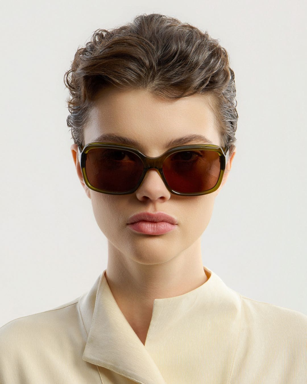 Female model wearing Corlin Eyewear Lana Olive Brown sunglasses — front view, bold squared Italian acetate frame