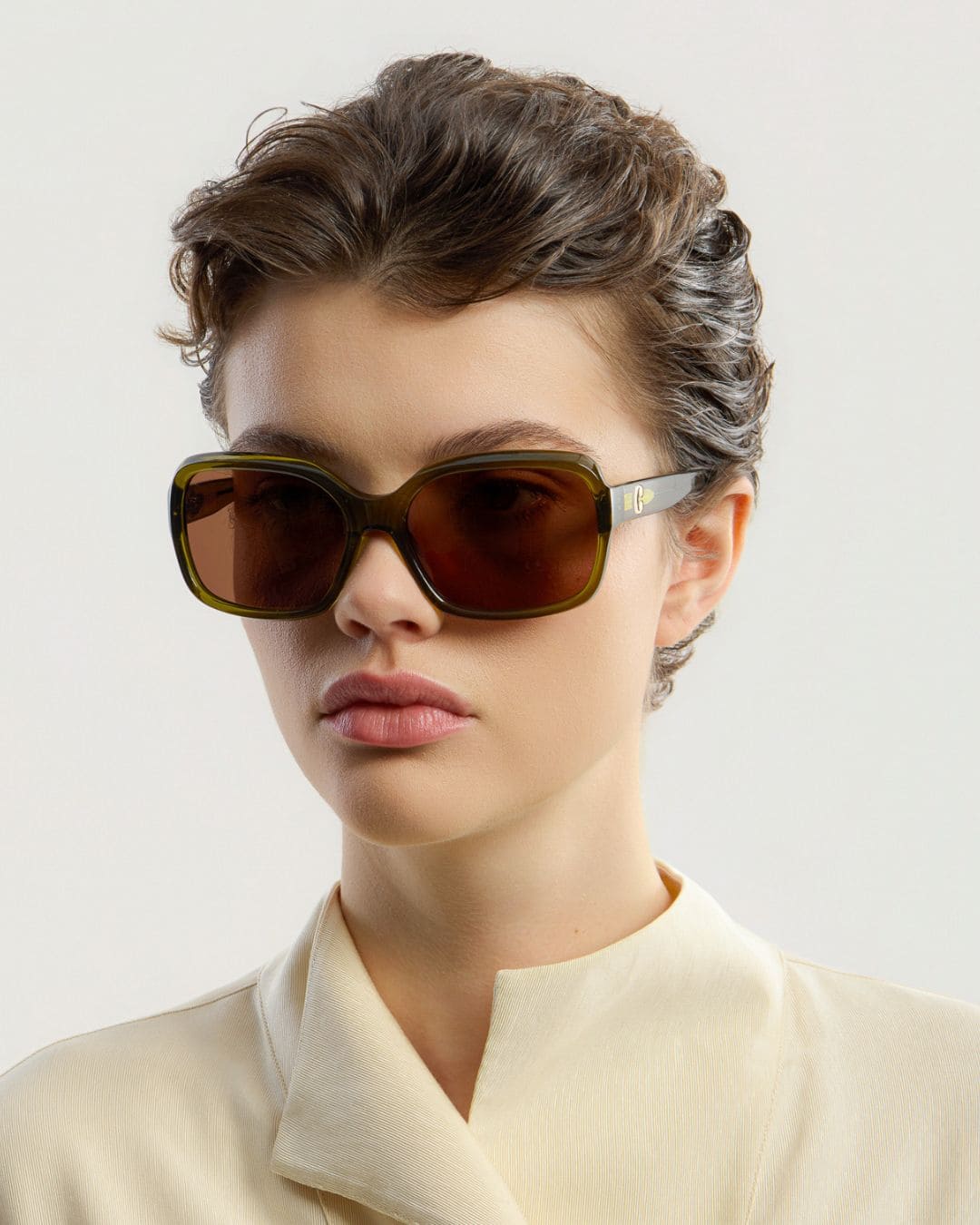 Female model wearing Corlin Eyewear Lana Olive Brown sunglasses — side profile, Swedish minimalist design