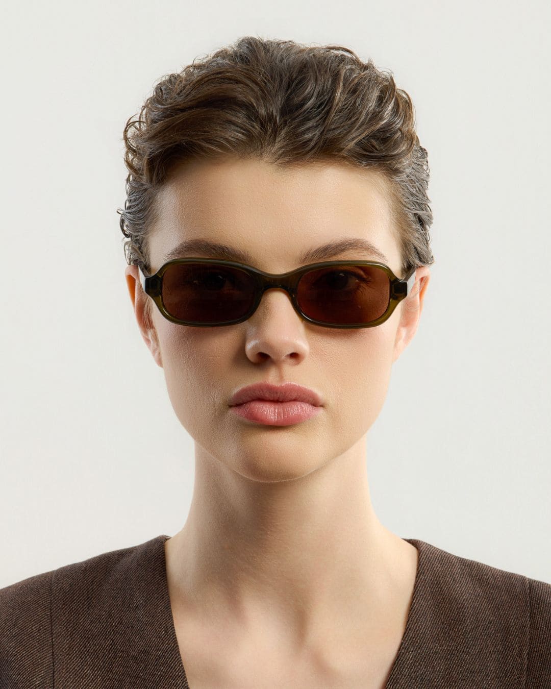 Woman wearing Lou Olive Brown sunglasses by Corlin from the front.