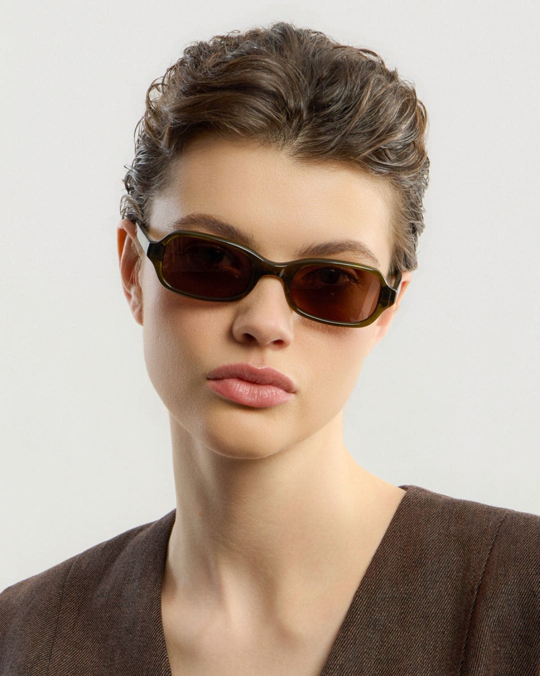 Female model wearing Corlin Eyewear Lou Olive Brown sunglasses — squared acetate sunglasses, Swedish design