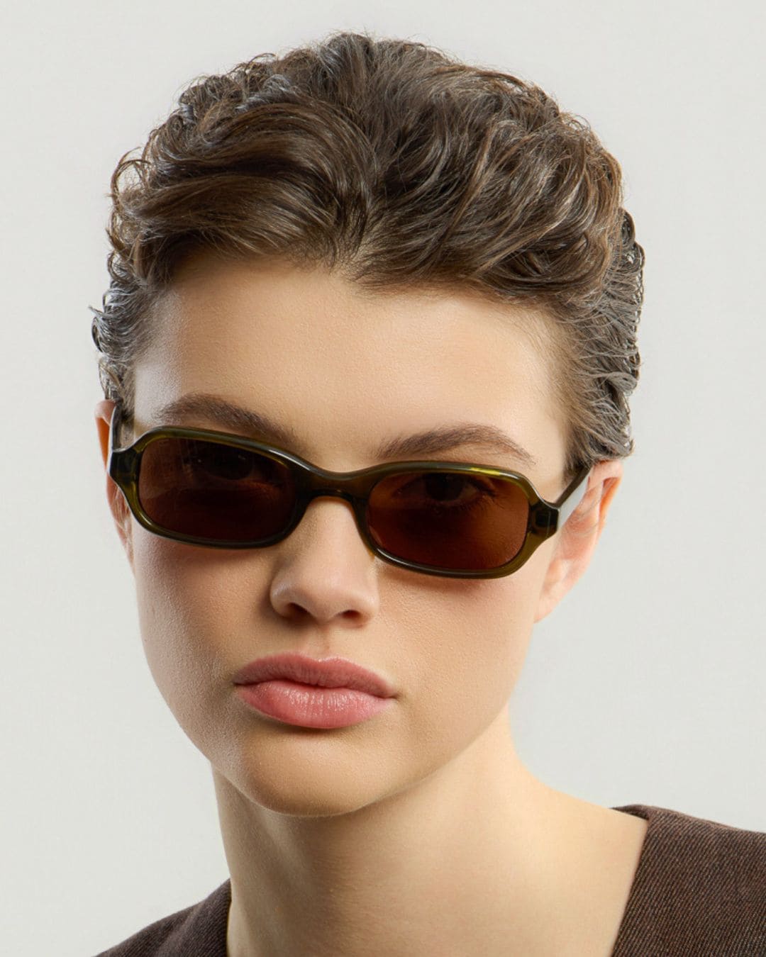 Woman wearing Lou Olive Brown sunglasses by Corlin.