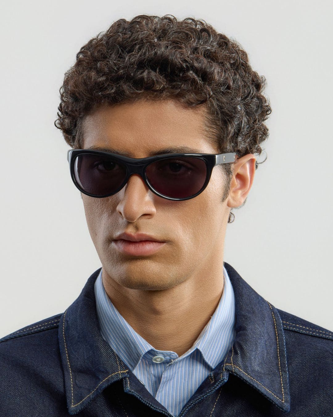 Male model wearing Corlin Eyewear Lynne Black sunglasses — side profile, wraparound fit on face