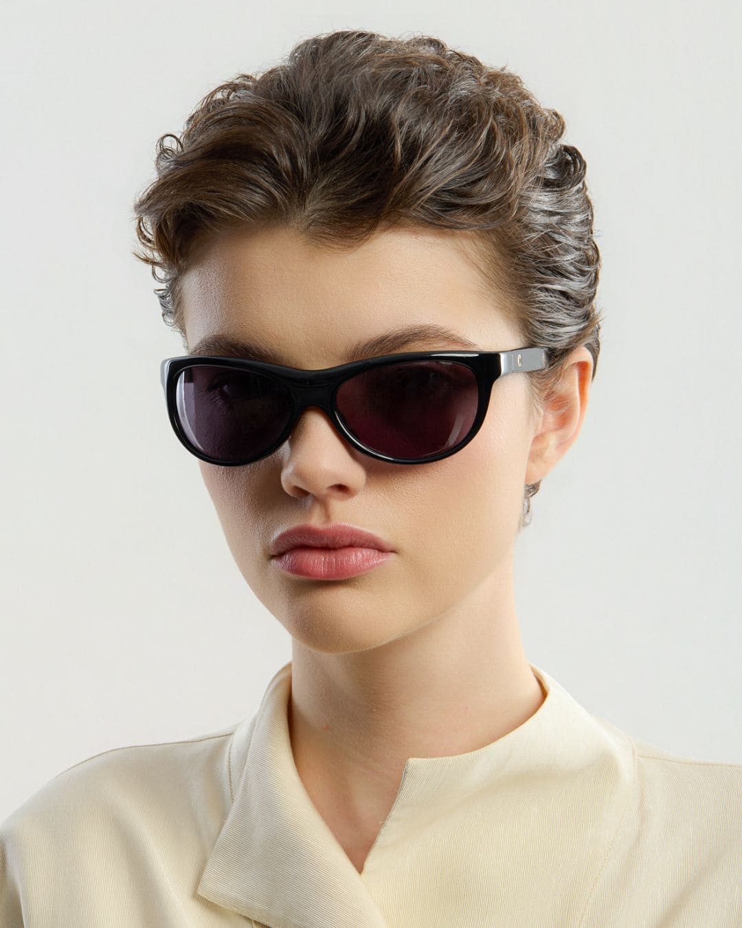 Female model wearing Corlin Eyewear Lynne Black sunglasses — side profile, Swedish minimalist wraparound design