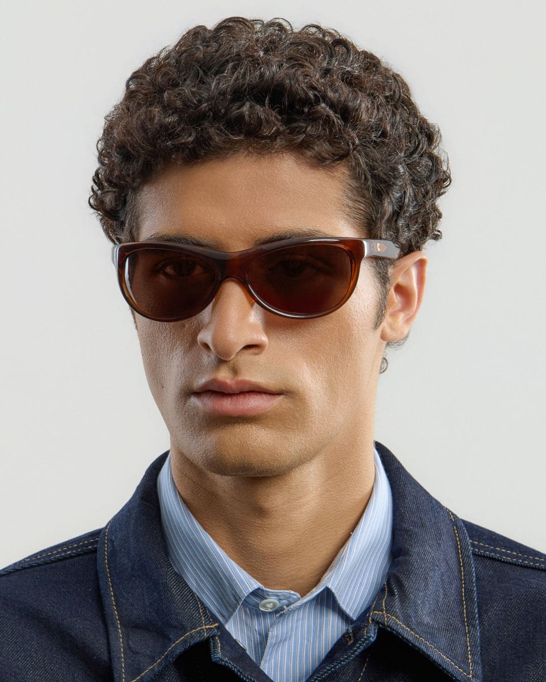 Male model wearing Corlin Eyewear Lynne Brown Brown sunglasses — side profile, wraparound fit on face