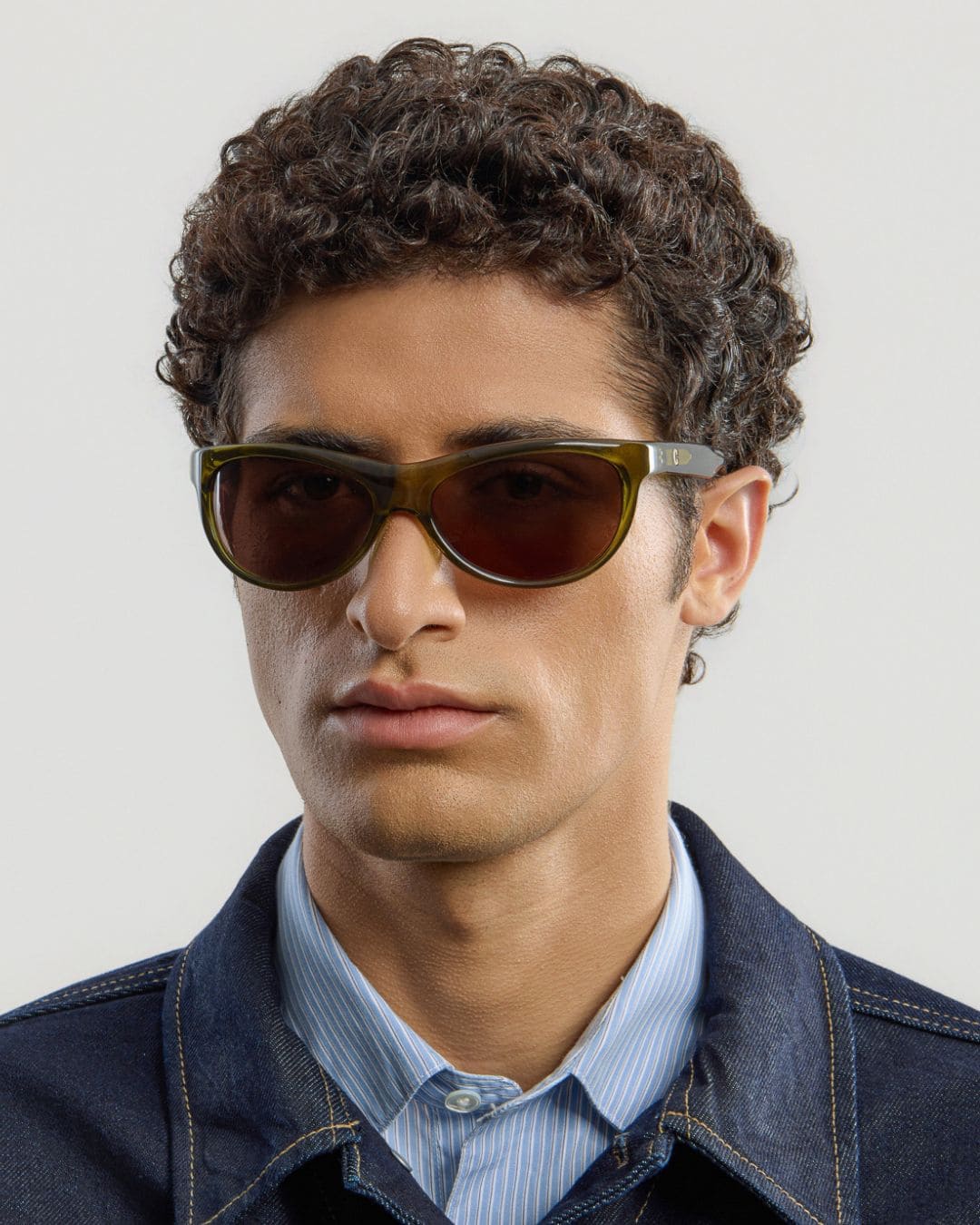 Male model wearing Corlin Eyewear Lynne Olive Brown sunglasses — side profile, wraparound fit on face