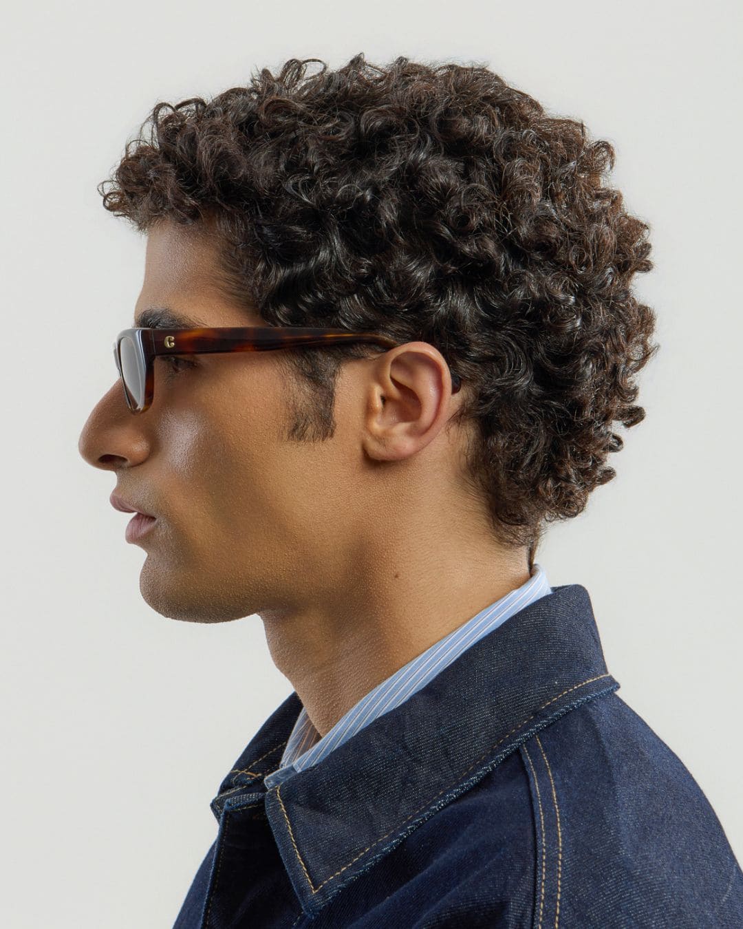 Male model wearing Corlin Eyewear Marcel Tortoise Brown sunglasses — profile view, cat-eye rectangular silhouette