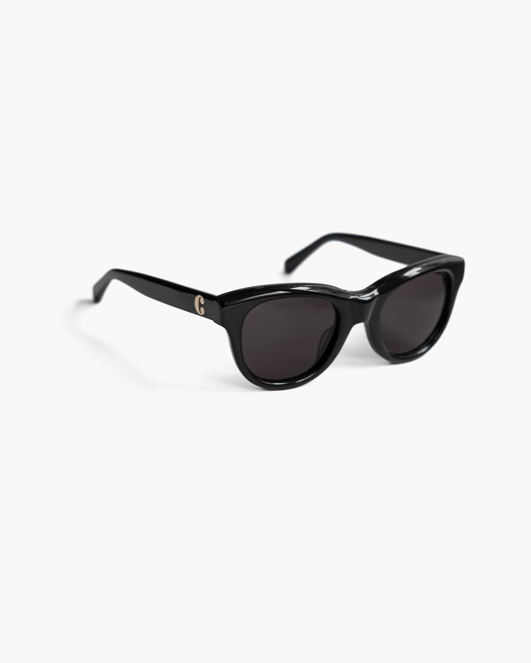 Black sunglasses on a white background slightly from the side