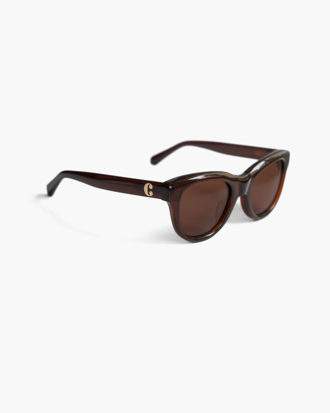 Brown sunglasses with a visible brand logo on a white background slightly from the side
