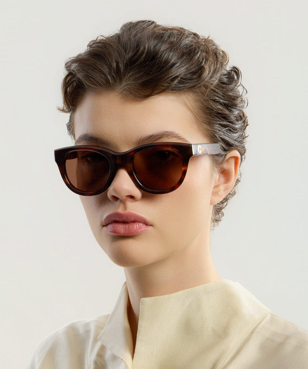 Female model wearing Corlin Eyewear Rey Tortoise Brown sunglasses — side profile, Swedish minimalist design