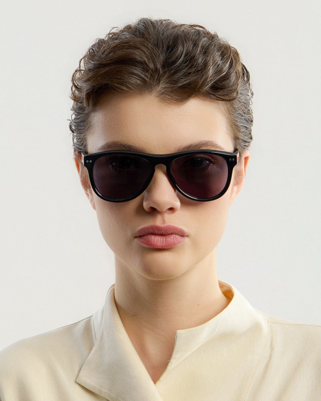 Female model wearing Corlin Eyewear Sonney Black Black sunglasses — front view, Italian acetate frame
