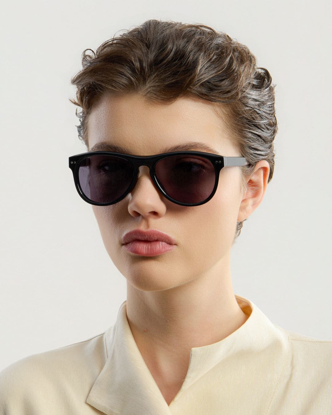 Female model wearing Corlin Eyewear Sonney Black Black sunglasses — side profile, Swedish minimalist design
