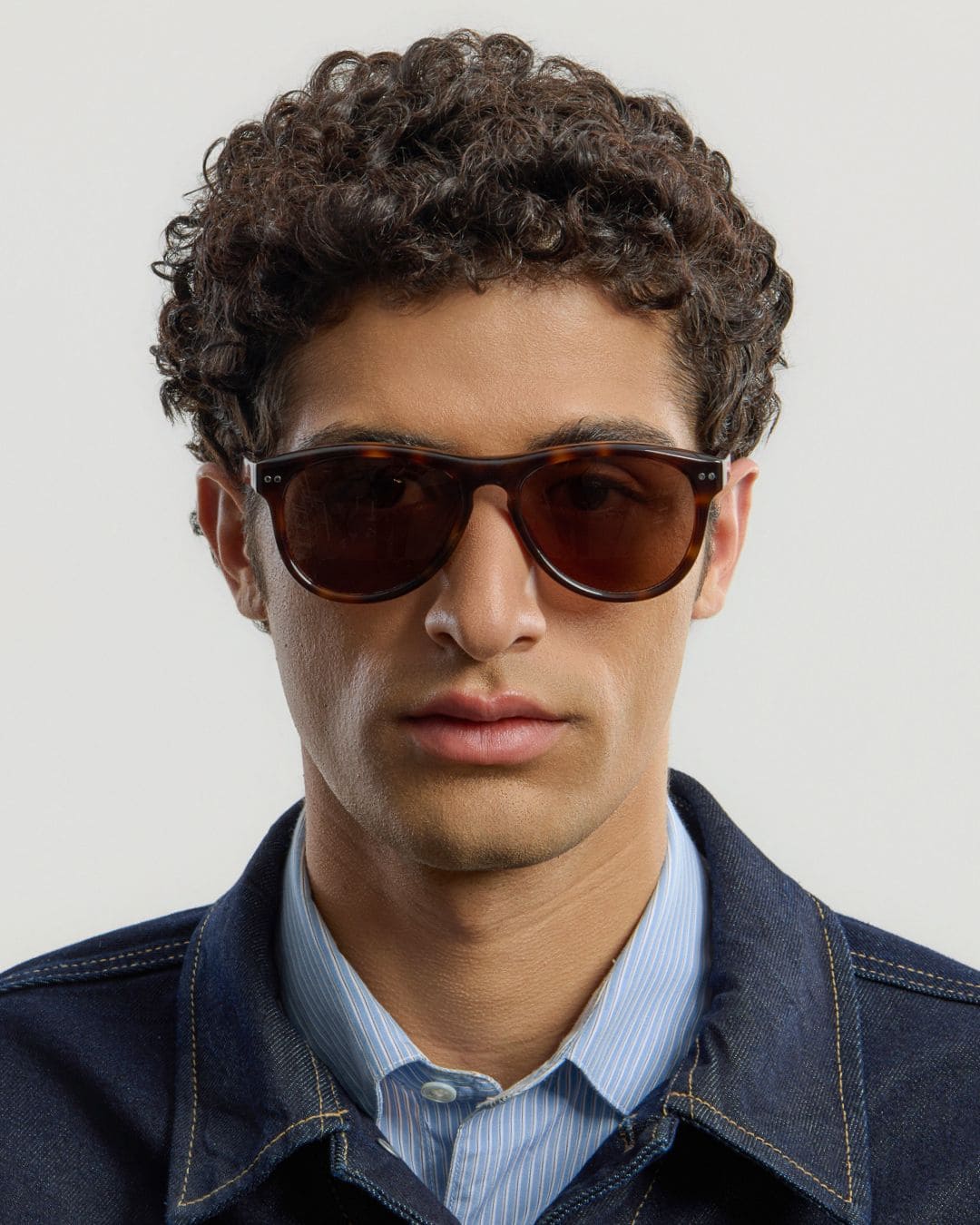 Male model wearing Corlin Eyewear Sonney Tortoise Brown sunglasses — front view, sculpted Italian acetate frame