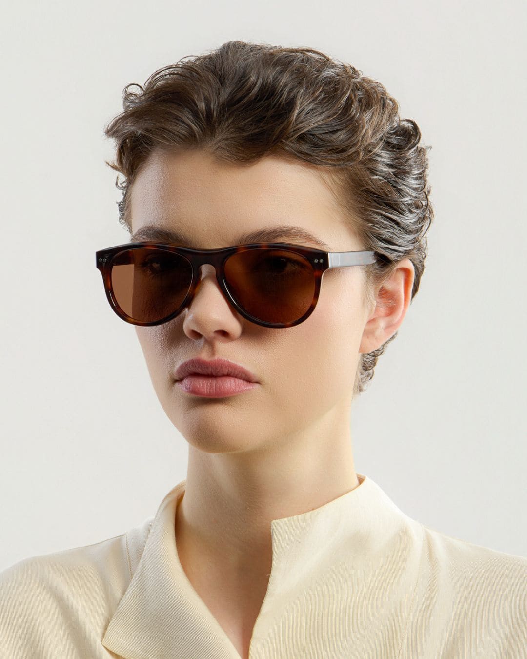 Female model wearing Corlin Eyewear Sonney Tortoise Brown sunglasses — side profile, Swedish minimalist design