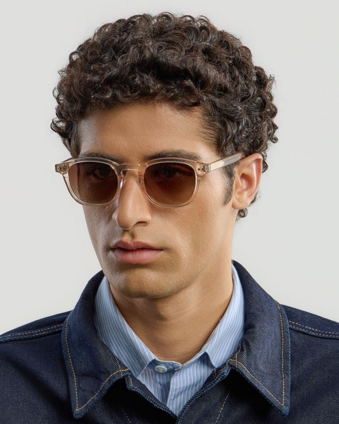 Man wearing champagne gradual brown sunglasses with a neutral background