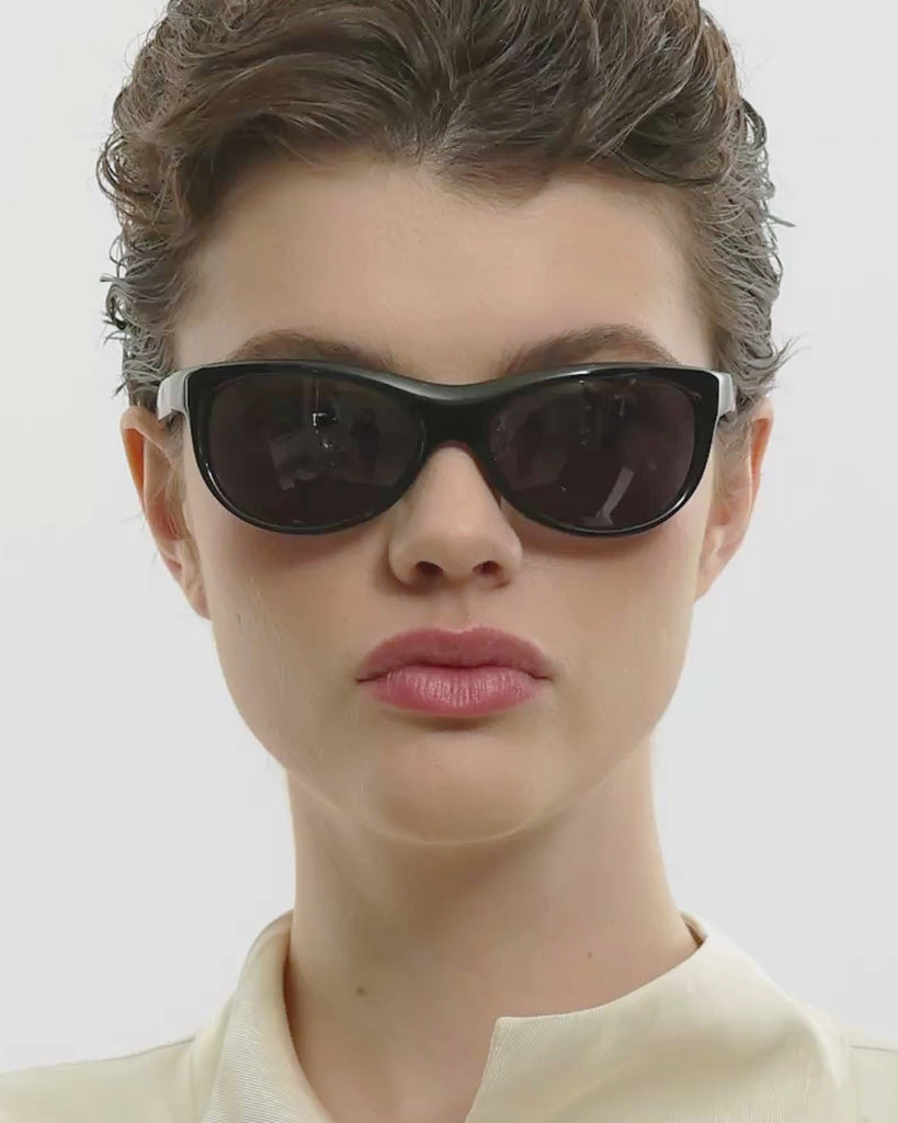 Female model wearing Corlin Eyewear Lynne Black sunglasses — video, Italian acetate wraparound frame
